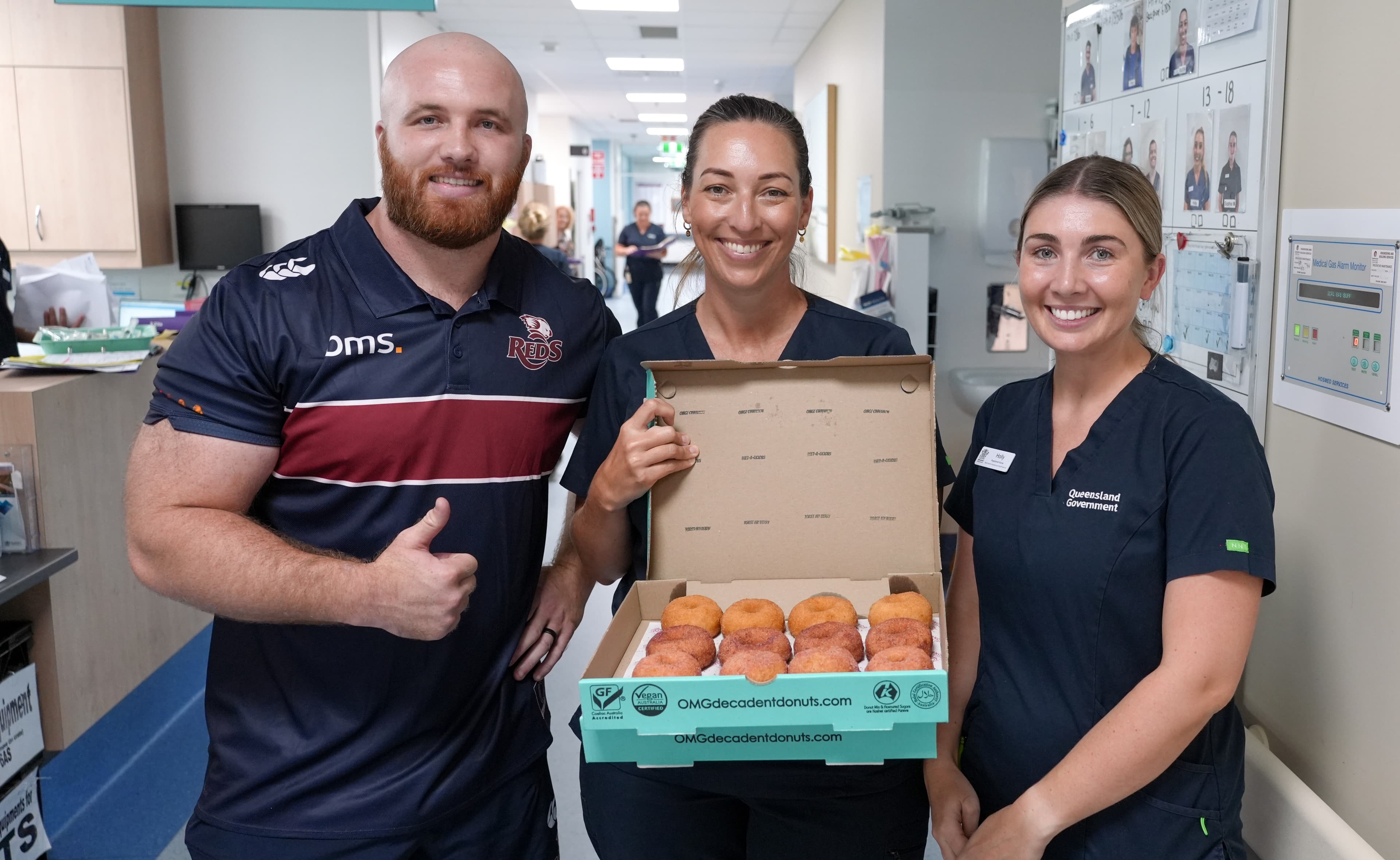 Donut delivery...Reds prop Matt Gibbon delivering treats to nurses at Royal Brisbane and Women's Hospital. Photos: Neha Kumar