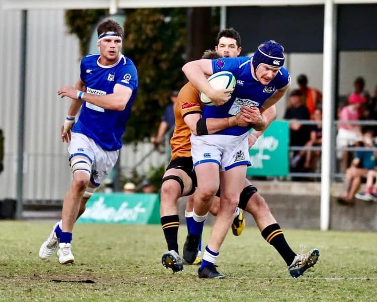 Oh the charge...Heelers flyhalf Trent Davison challenging the NSW Country defence in Caloundra